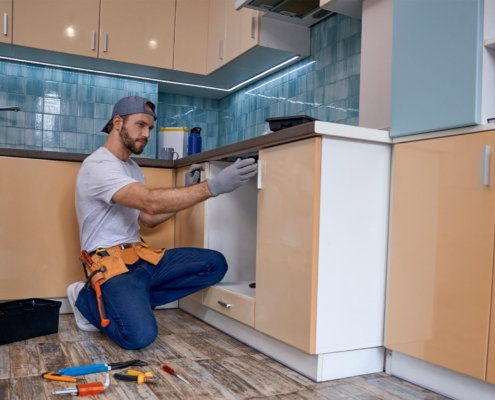 Image of a person measuring new kitchen cabinets