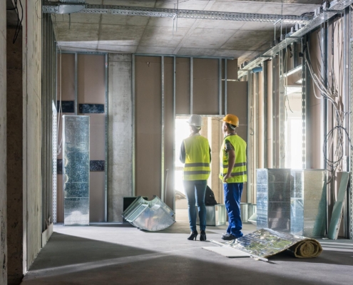 Two workers renovating a commercial space